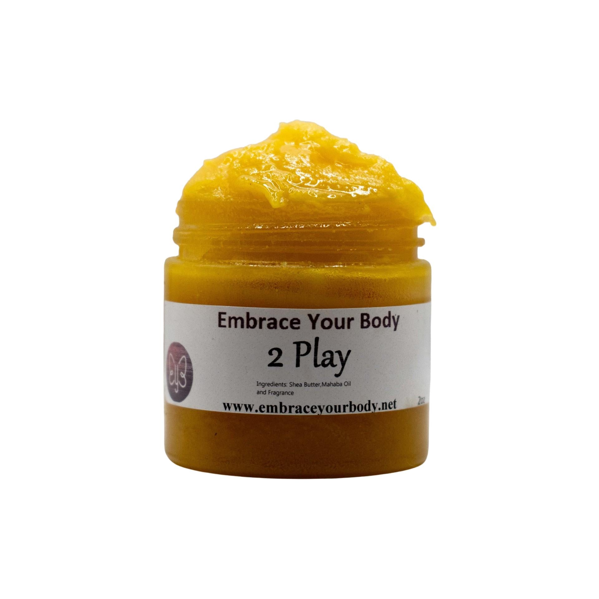 Yellow massaging cream in a glass jar with a Embrace your Body "2 Play" with a white blackground